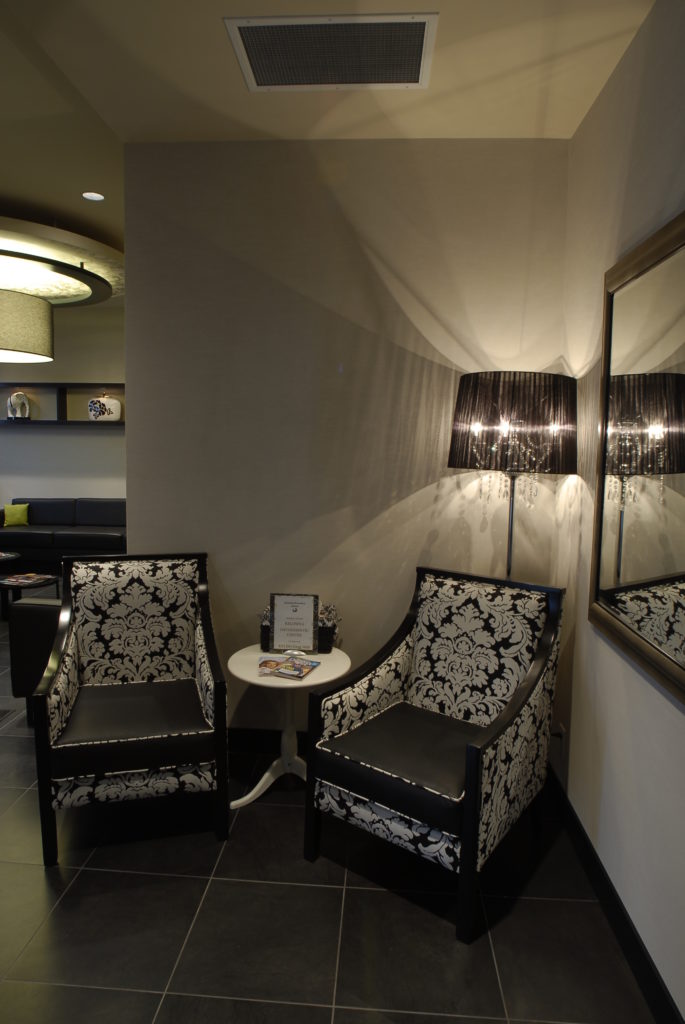 Black and white Jacquard print accent chairs in a hall in Kelowna Orthodontic office.