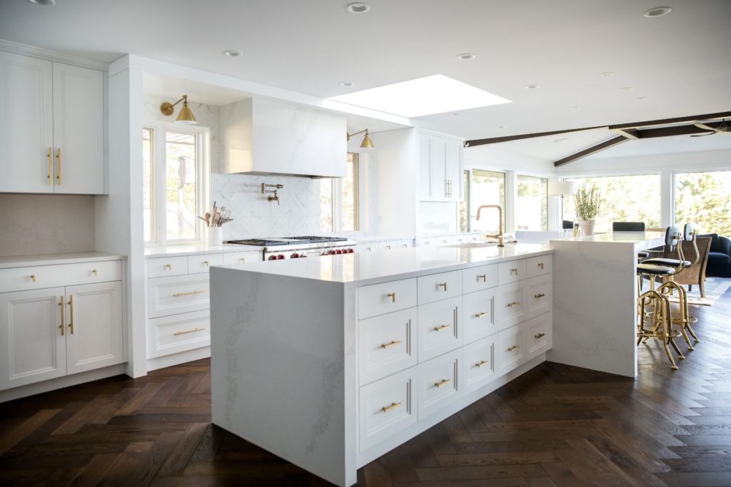 White kitchen island with gold hardware in Kelowna residential renovation construction project.