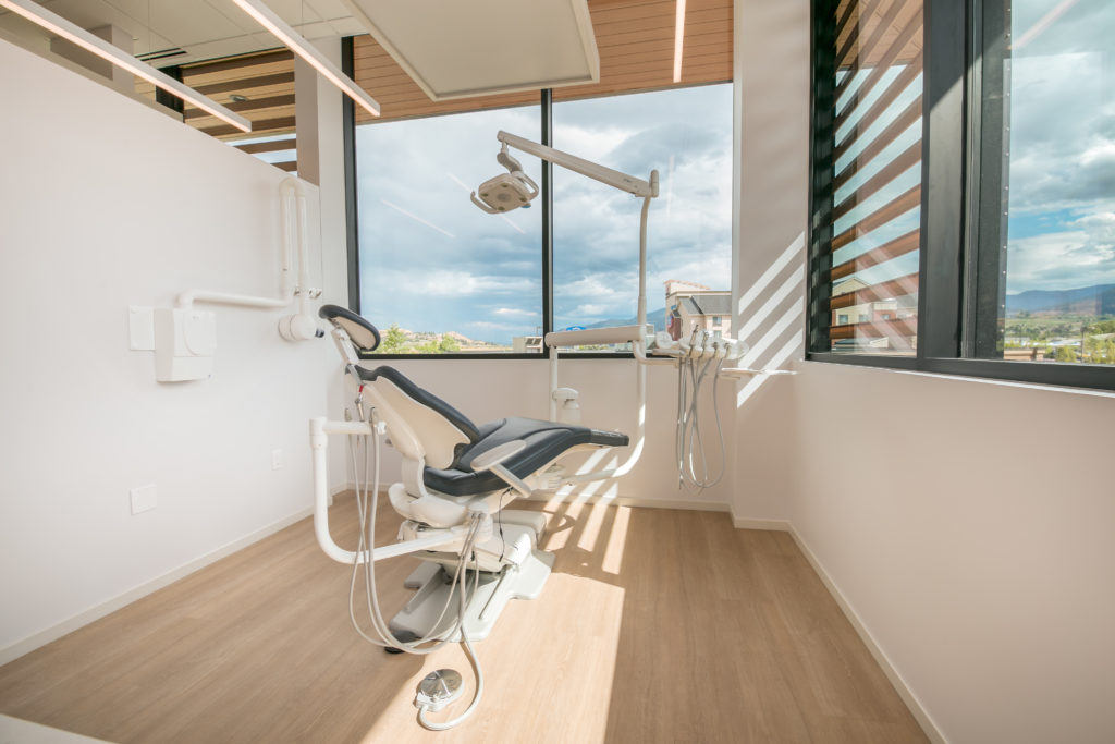 Treatment room with large windows at Vernon dentist clinic.