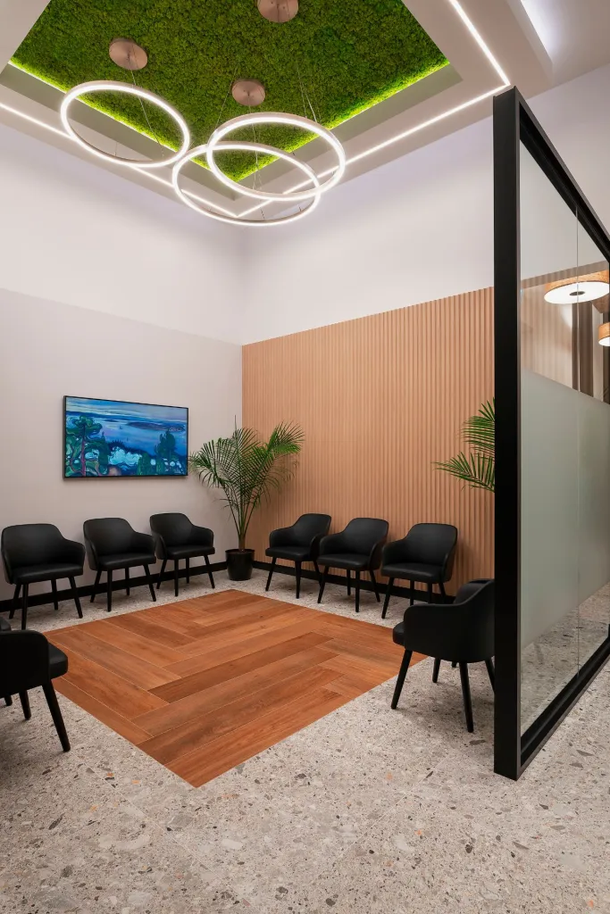 the waiting room at glenmore dental with wood and plant accents