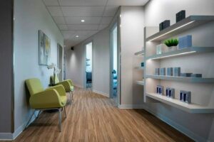 DermMedica medical clinic waiting area with shelves of products and green chairs