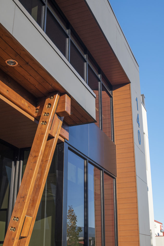 A close-up of the front windows and beams of the Fredex/Adams Road Industrial building.  